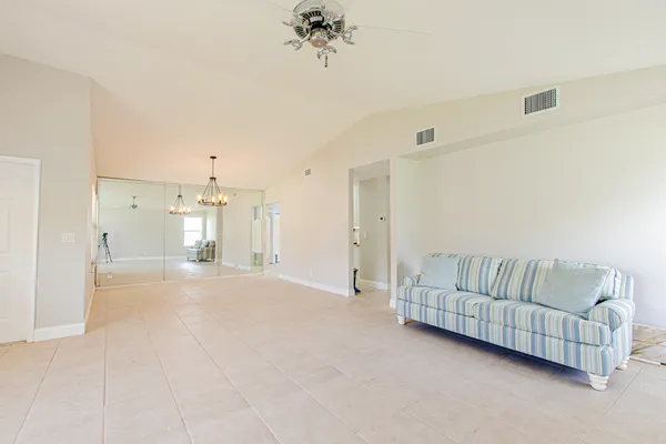 a living room with furniture and a chandelier