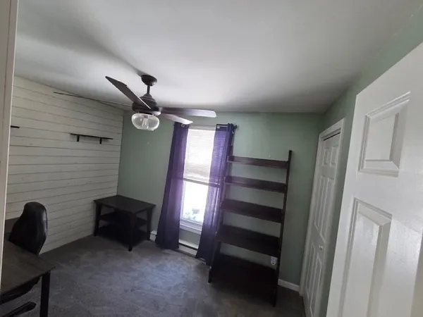 a view of room with a ceiling fan and window