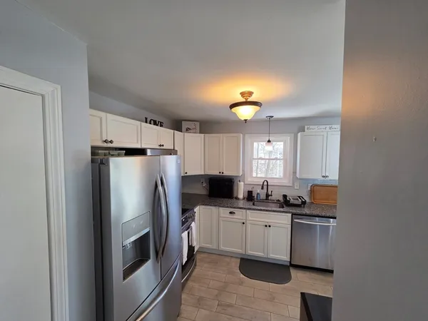 a kitchen with a sink appliances and cabinets