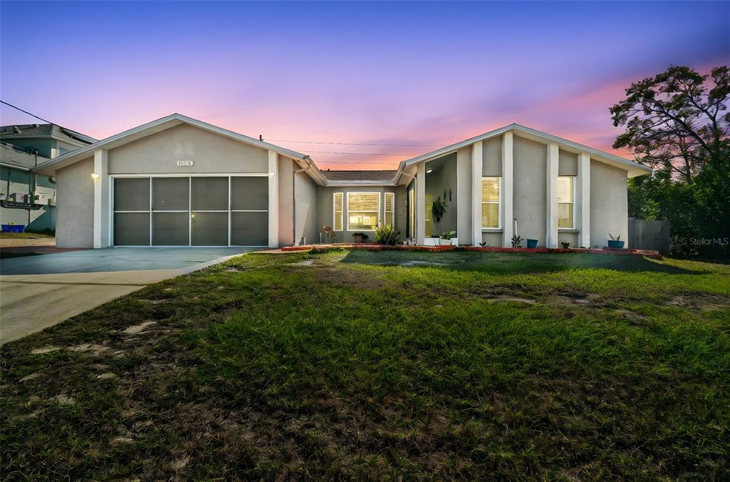 13170 Pirate Lane Spring Hill, FL 34609 - Photo 1 of 83 a front view of a house with a yard and garage