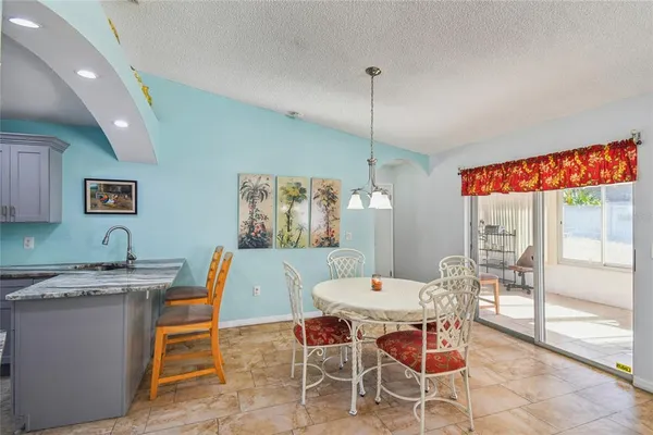 a view of a room that has a bed and a table in it
