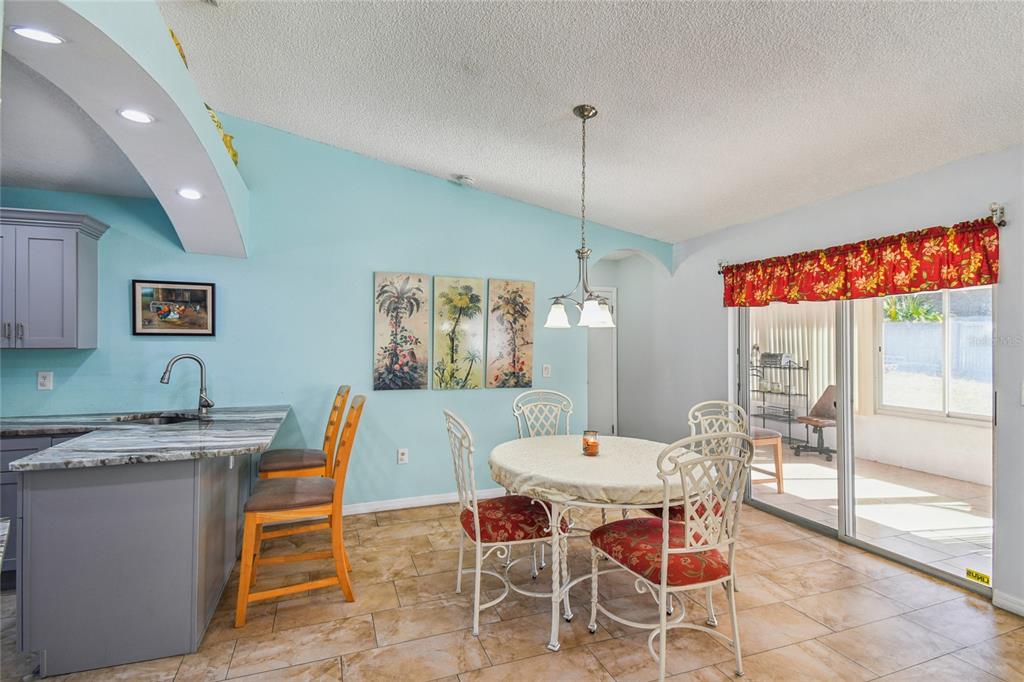 13170 Pirate Lane Spring Hill, FL 34609 - Photo 20 of 83 a dining room with a table and chairs