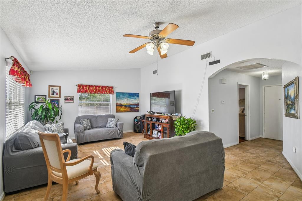13170 Pirate Lane Spring Hill, FL 34609 - Photo 24 of 83 a living room with furniture and a chandelier