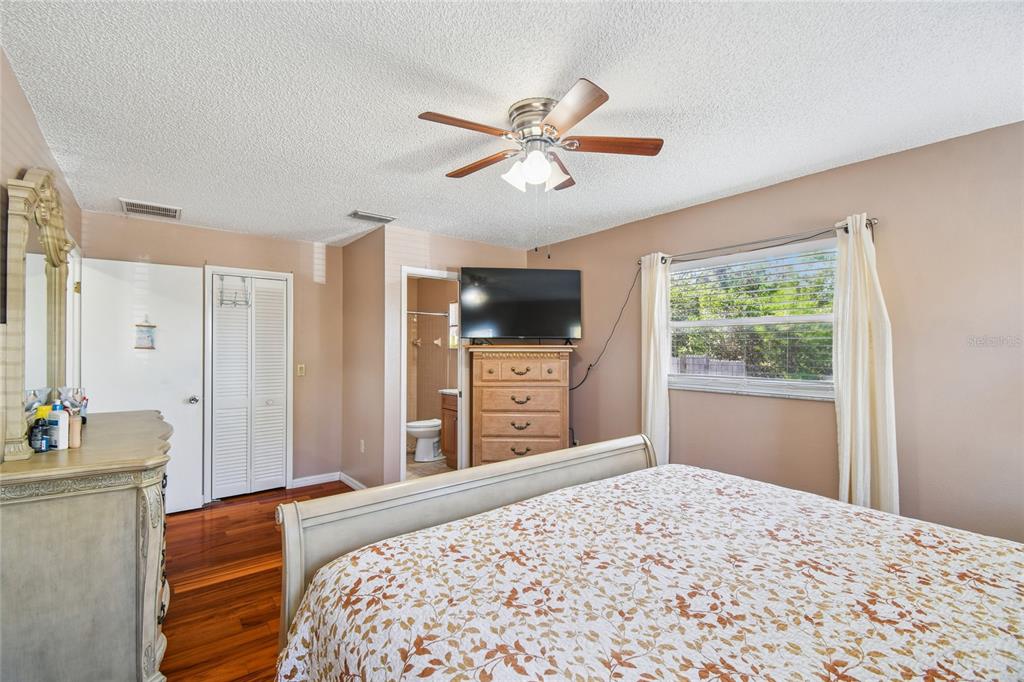 13170 Pirate Lane Spring Hill, FL 34609 - Photo 37 of 83 a bedroom with a bed and a flat screen tv