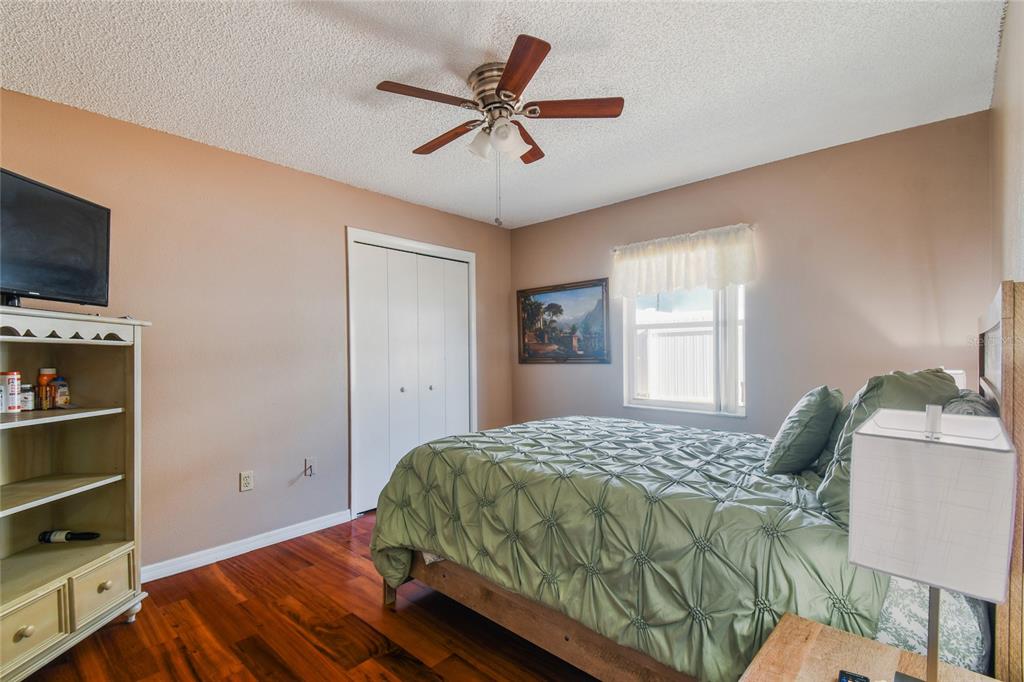 13170 Pirate Lane Spring Hill, FL 34609 - Photo 41 of 83 a bedroom with a bed and a television