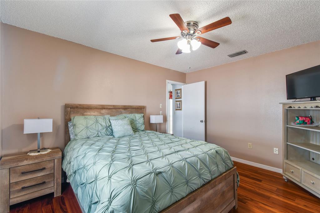 13170 Pirate Lane Spring Hill, FL 34609 - Photo 42 of 83 a bedroom with a bed and a flat screen tv