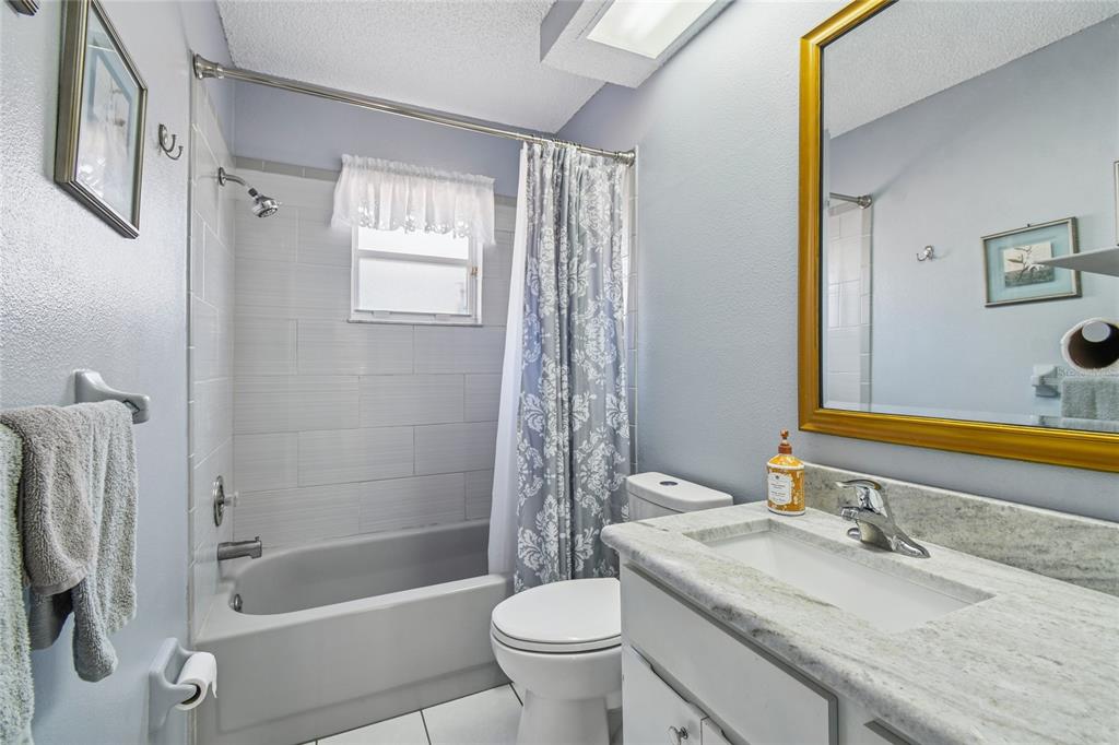 13170 Pirate Lane Spring Hill, FL 34609 - Photo 44 of 83 a bathroom with a granite countertop sink toilet and shower