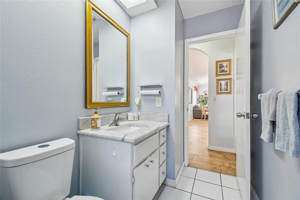 13170 Pirate Lane Spring Hill, FL 34609 - Photo 45 of 83 a bathroom with a granite countertop sink and a mirror