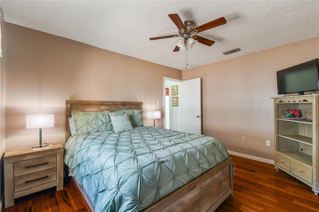 13170 Pirate Lane Spring Hill, FL 34609 - Photo 48 of 83 a bedroom with a bed and a flat screen tv