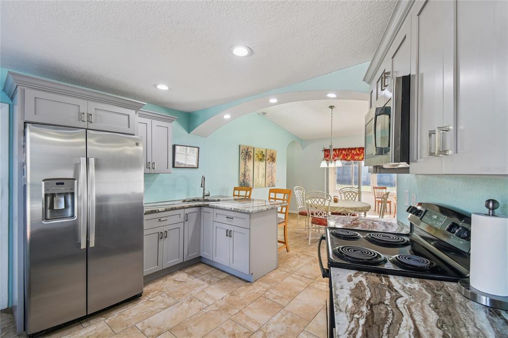 13170 Pirate Lane Spring Hill, FL 34609 - Photo 10 of 83 a kitchen with lots of counter top space appliances and a center island