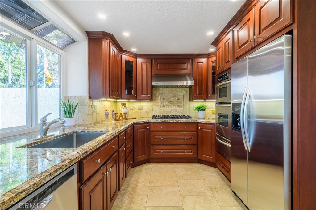 5 Telliz Rancho Santa Margarita, CA 92688 - Photo 13 of 58 a kitchen with stainless steel appliances granite countertop a refrigerator and a sink