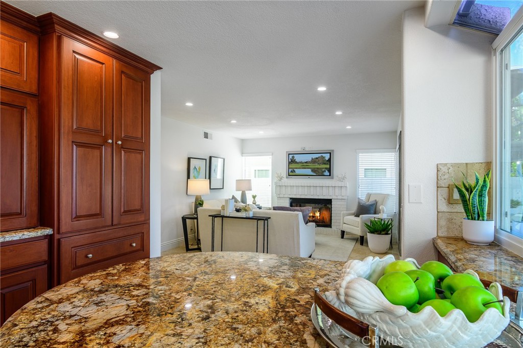 5 Telliz Rancho Santa Margarita, CA 92688 - Photo 15 of 58 a living room with furniture a fireplace and a flat screen tv