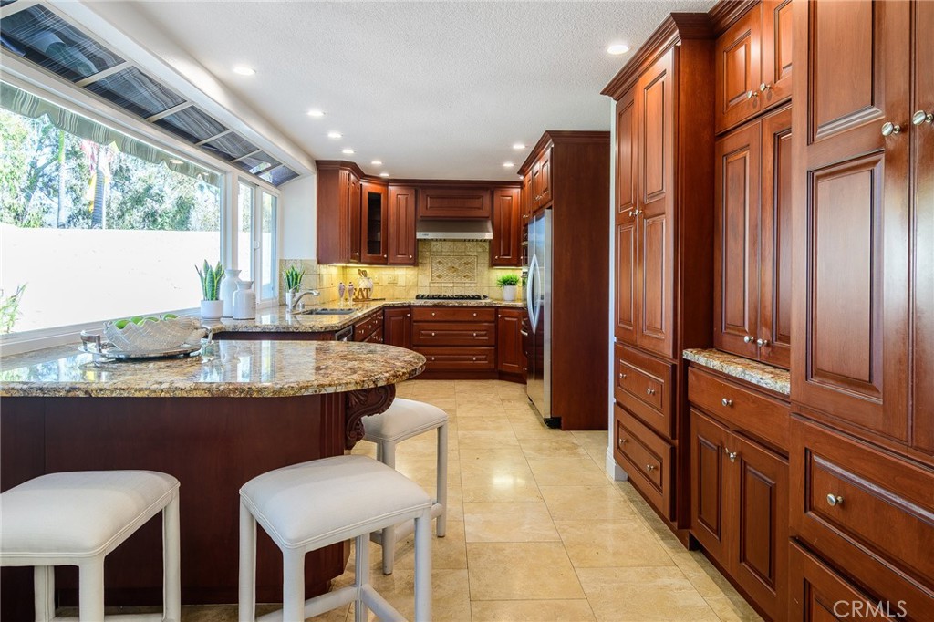 5 Telliz Rancho Santa Margarita, CA 92688 - Photo 16 of 58 a kitchen with granite countertop a sink and cabinets