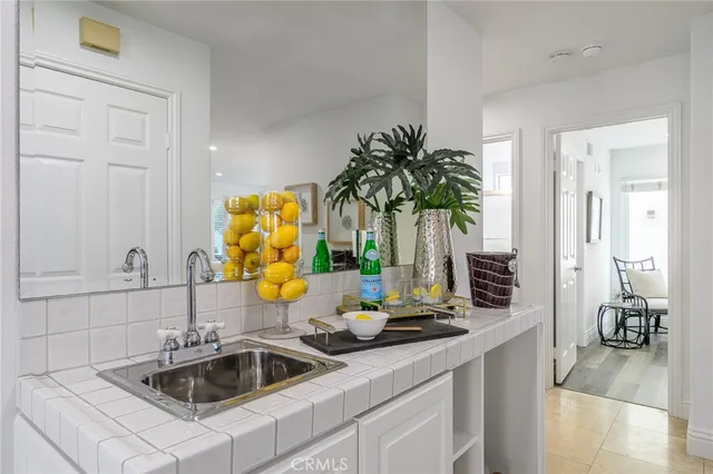 a kitchen with a sink and a potted plant