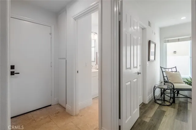 a view of a room with wooden floor lounge chair and windows