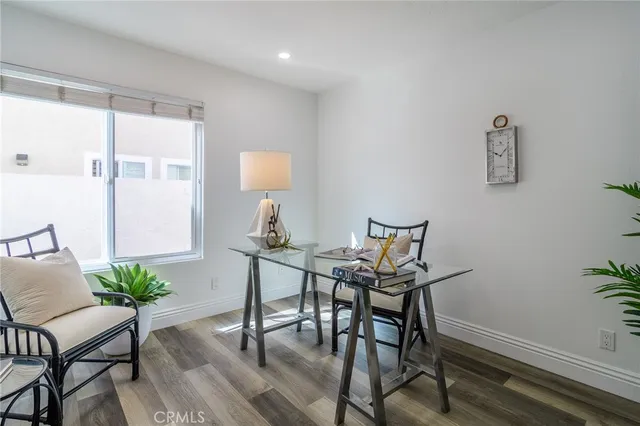 a view of a workspace room with furniture and wooden floor