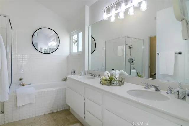 a bathroom with double vanity sinks and a mirror