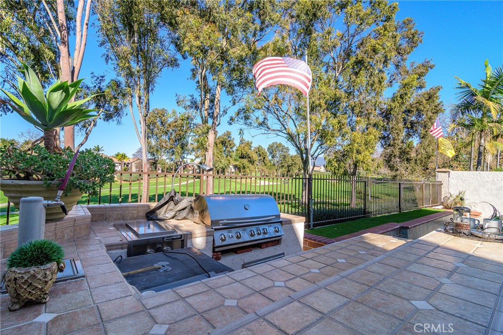 5 Telliz Rancho Santa Margarita, CA 92688 - Photo 46 of 58 a backyard of a house with barbeque oven fire pit table and chairs