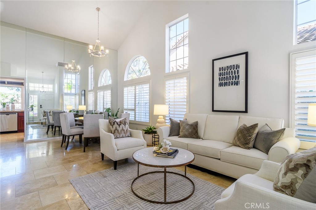 5 Telliz Rancho Santa Margarita, CA 92688 - Photo 7 of 58 a living room with furniture a large window and a dining table