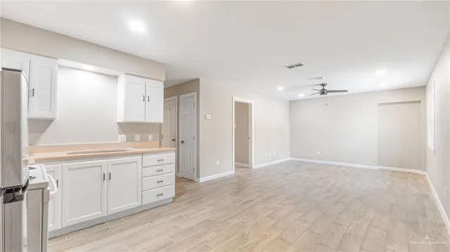 a view of a kitchen with granite countertop cabinets and wooden floor