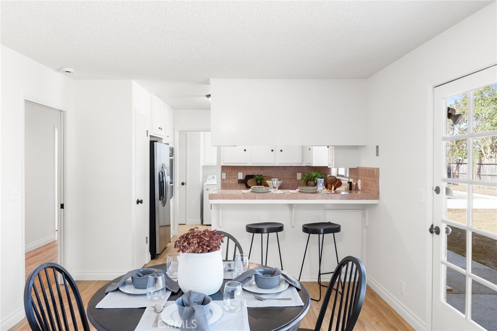 8 Cottage Circle Chico, CA 95926 - Photo 13 of 46 a view of a dining room with furniture a kitchen and chandelier