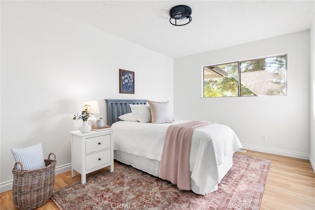 8 Cottage Circle Chico, CA 95926 - Photo 22 of 46 a bedroom with a bed and wooden floor