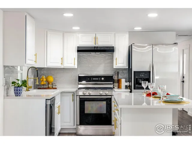 a kitchen with stainless steel appliances a stove microwave and cabinets