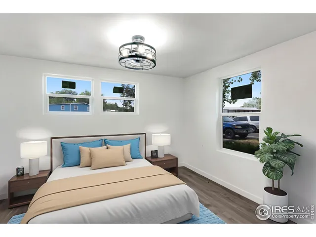 a bedroom with a bed and a potted plant