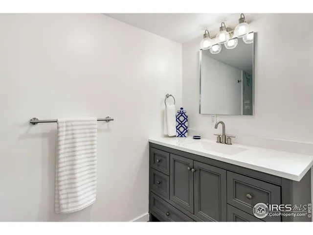 a bathroom with a sink vanity and a mirror