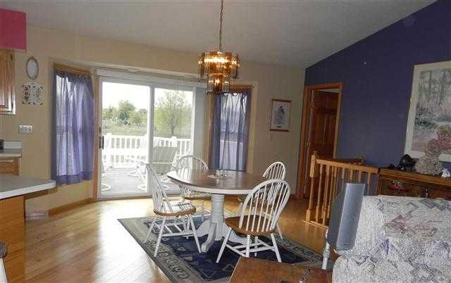 9967 East Center Road Stockton, IL 61085 - Photo 4 of 12 a dining room with furniture a chandelier and wooden floor