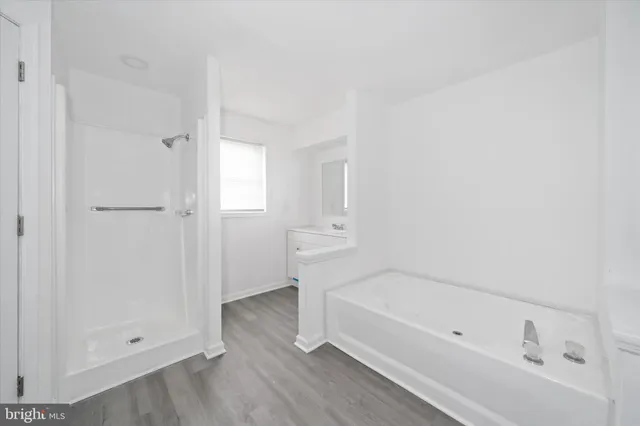 a bathroom with a bathtub and a shower