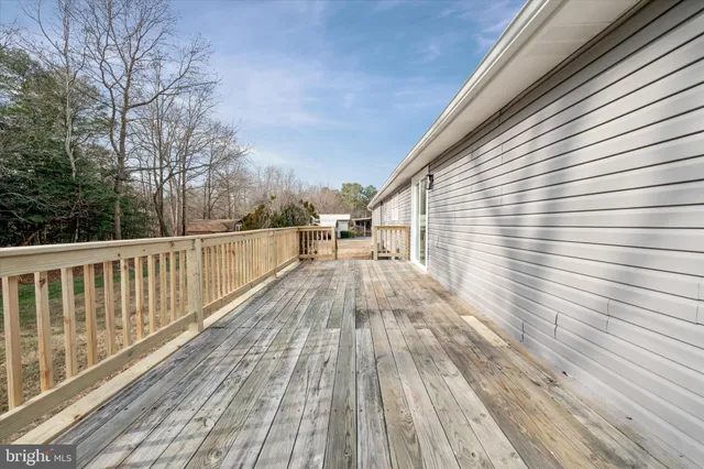 a view of balcony with wooden floor and fence