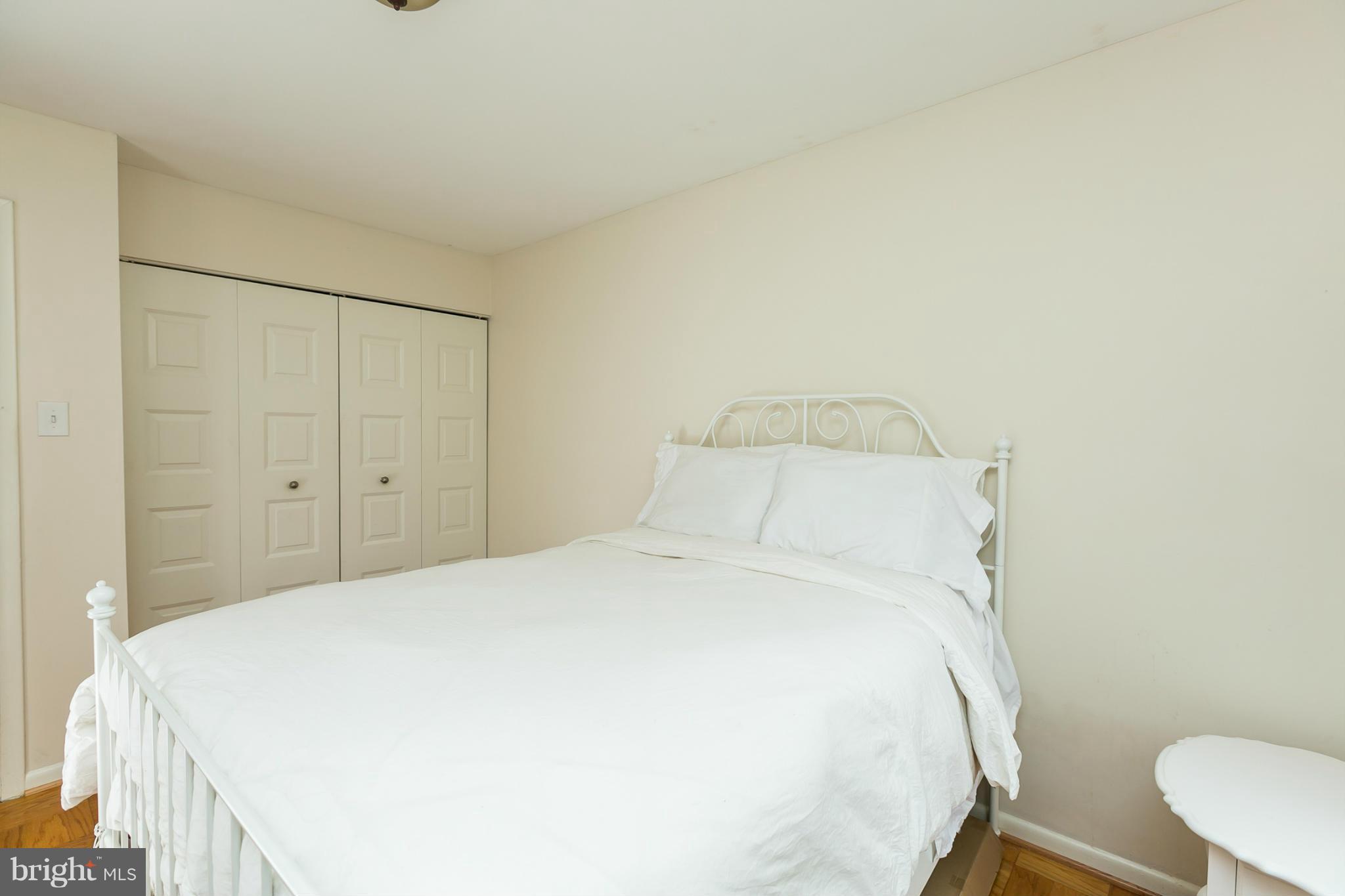 5235 West Running Brook Road, Unit 302 Columbia, MD 21044 - Photo 19 of 29 a large bed sitting in a bedroom next to a bathroom