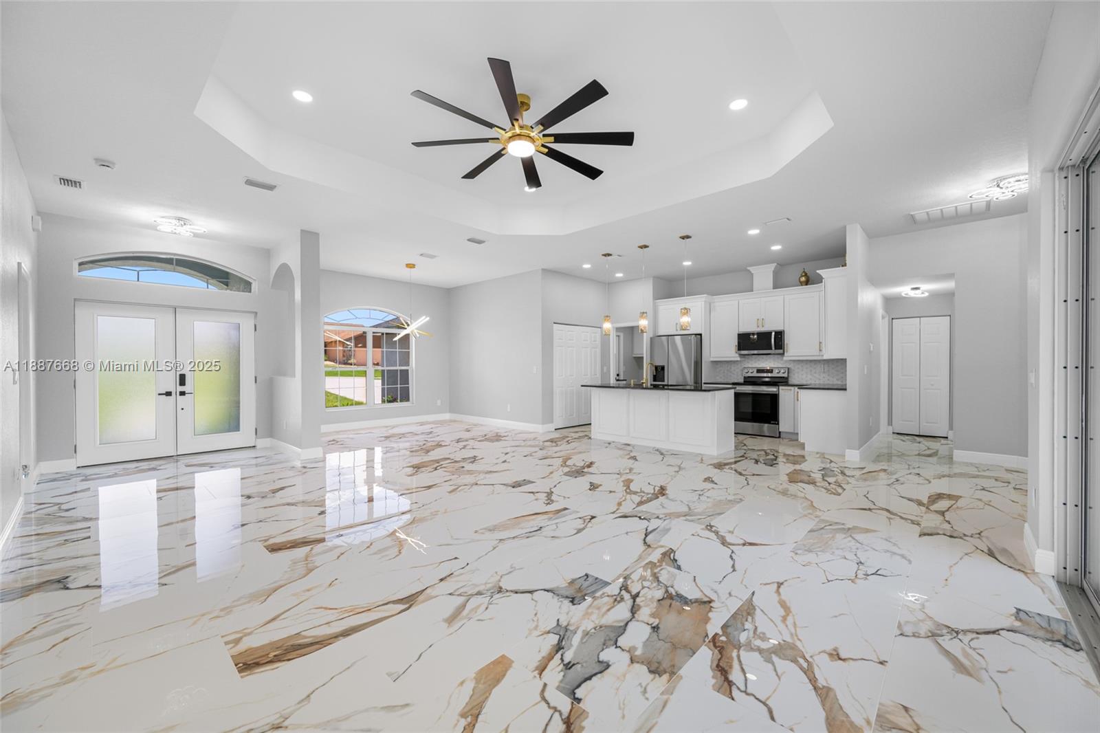 5317 Lydia Court Spring Hill, FL 34608 - Photo 2 of 10 a view of a kitchen with kitchen island a refrigerator sink cabinets and a counter top space