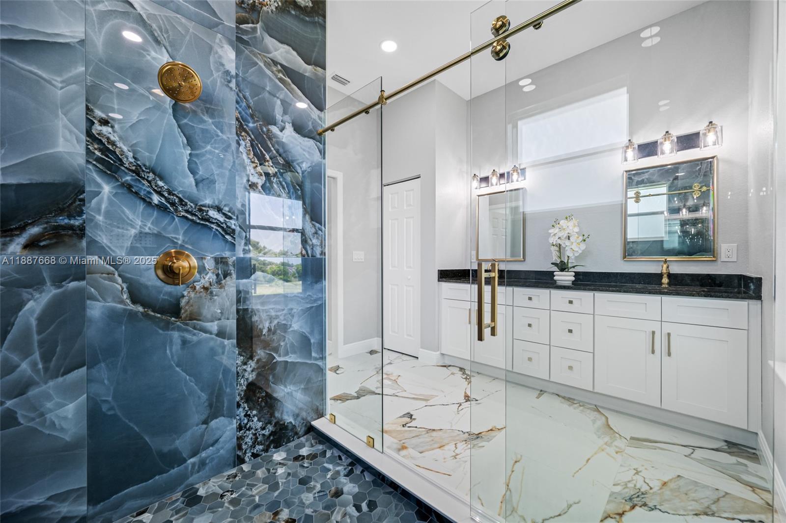 5317 Lydia Court Spring Hill, FL 34608 - Photo 3 of 10 a bathroom with a double vanity sink mirror and shower