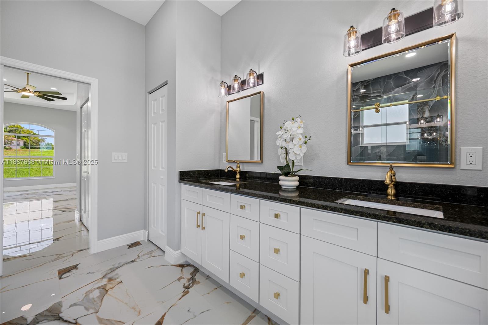 5317 Lydia Court Spring Hill, FL 34608 - Photo 4 of 10 a bathroom with double sink and a mirror