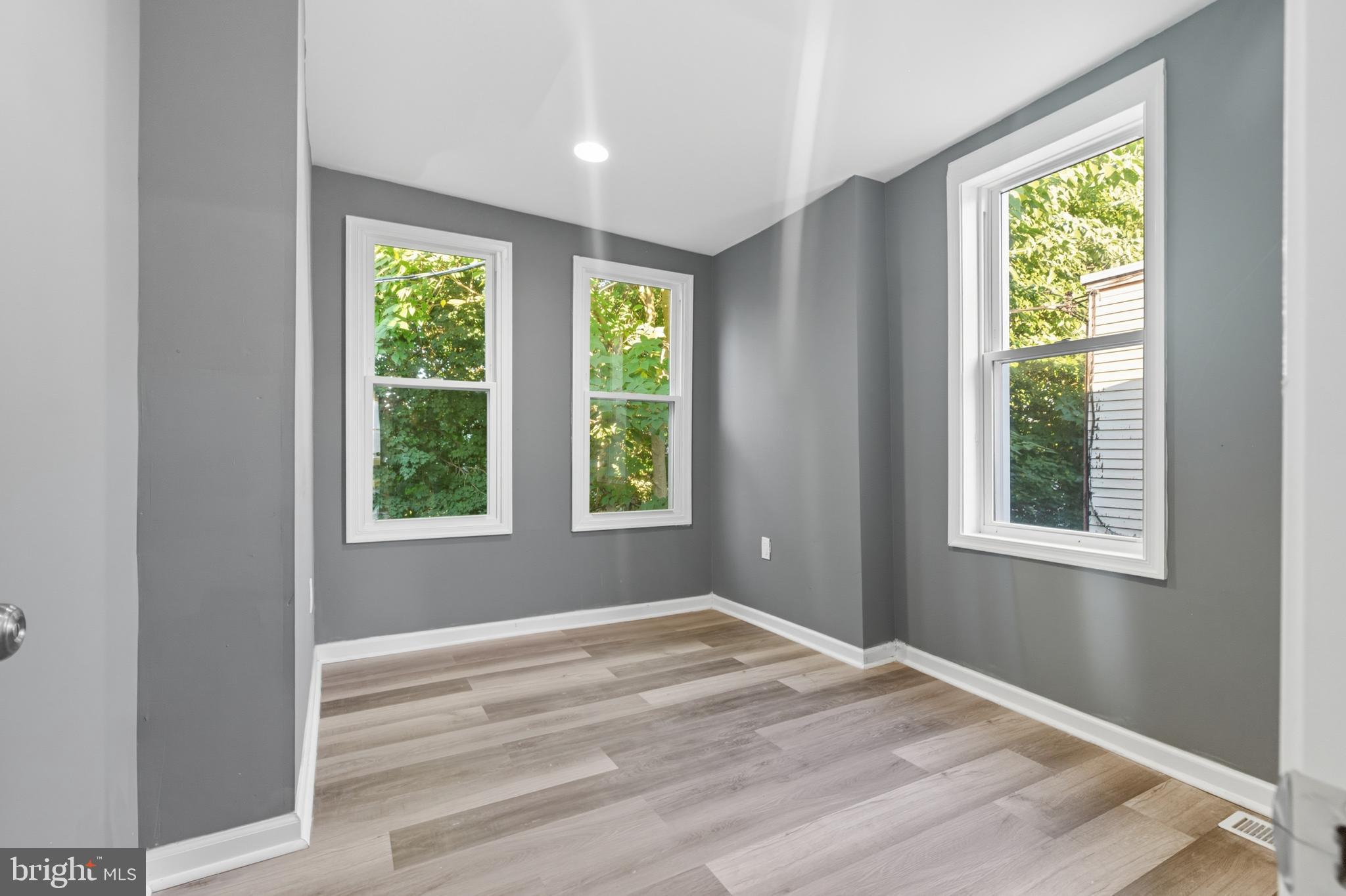 1307 Hanson Street Philadelphia, PA 19143 - Photo 13 of 19 a view of an empty room with wooden floor and a window