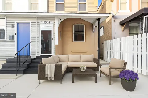 a front view of a house with outdoor seating