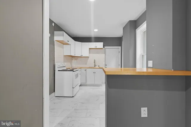 a kitchen with a sink cabinets and window
