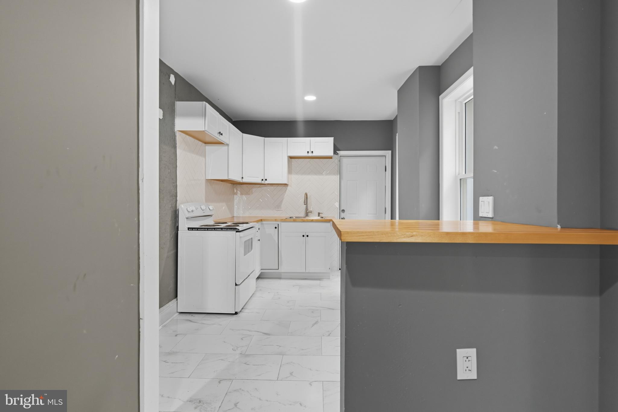 1307 Hanson Street Philadelphia, PA 19143 - Photo 4 of 19 a kitchen with a sink cabinets and window