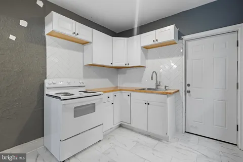 a kitchen with cabinets appliances and a sink