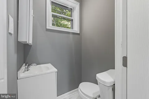 a white toilet sitting next to a bathroom sink