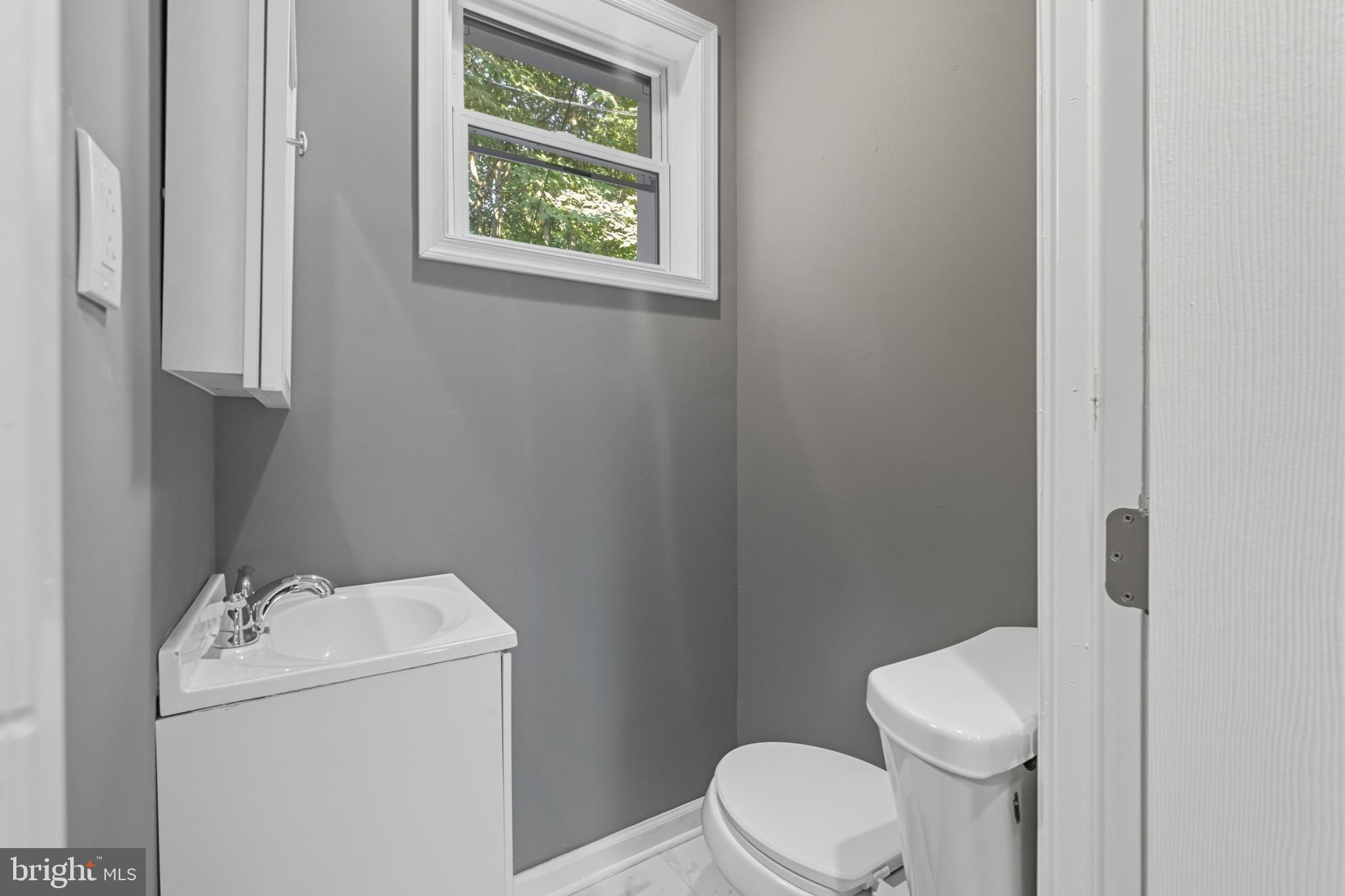 1307 Hanson Street Philadelphia, PA 19143 - Photo 7 of 19 a white toilet sitting next to a bathroom sink