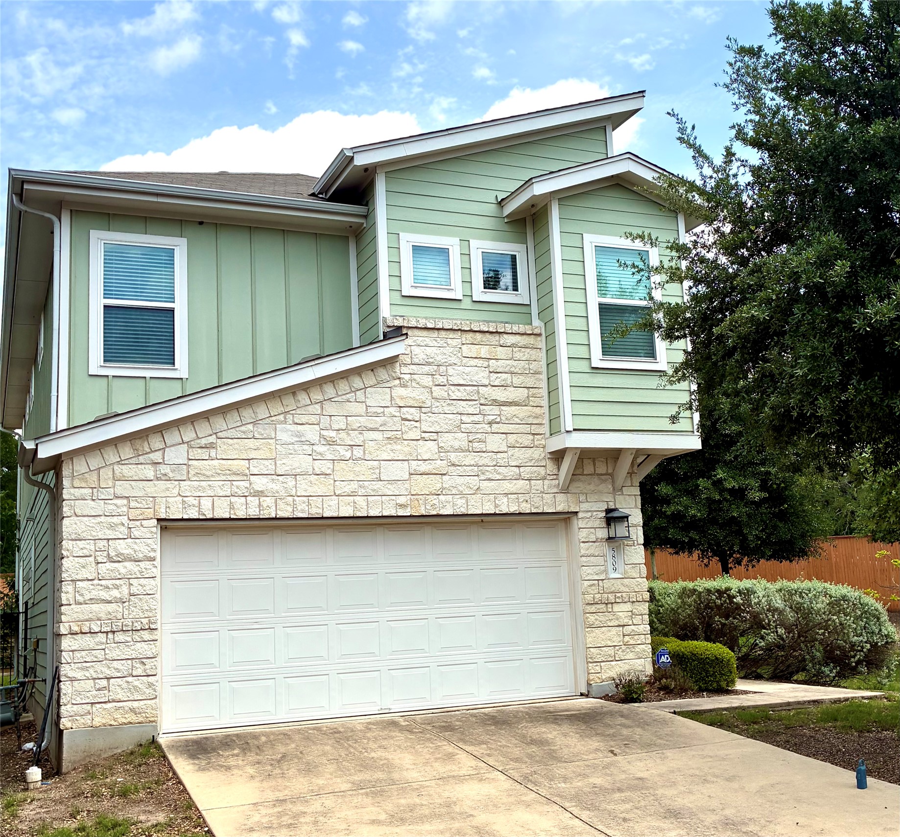 5809 Swayden Lane Austin, TX 78745 - Photo 2 of 10 Contemporary facade featuring light green siding and stone veneer