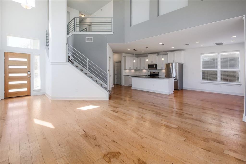 5809 Swayden Lane Austin, TX 78745 - Photo 3 of 10 Expansive open-concept interior featuring light wood-finish flooring