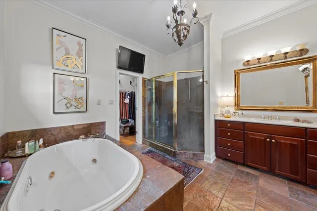 a spacious bathroom with a tub sink and mirror