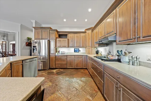 a kitchen with refrigerator cabinets and wooden floor