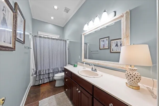 a bathroom with a double vanity sink mirror and toilet