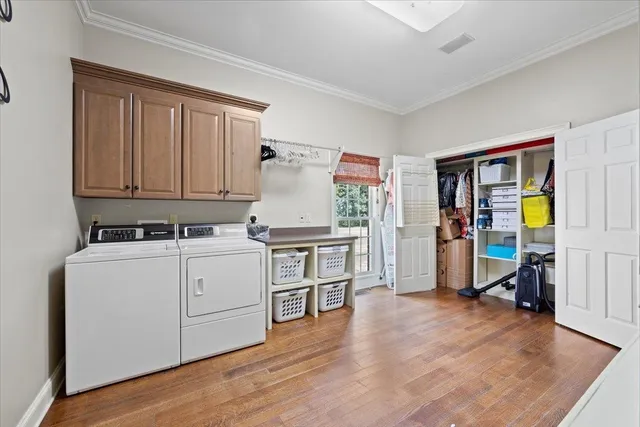 a kitchen with cabinets and wooden floor