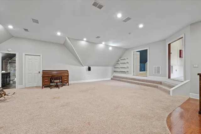 an empty room with wooden floor and furniture